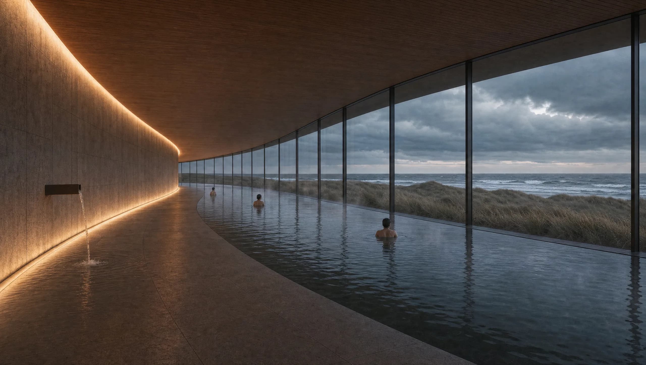 Concept view of a curving thermal bathing hall following the arc of the ring, a long dark still pool beside a honed stone wall, with a continuous band of glazing framing dunes and a grey North Sea horizon.